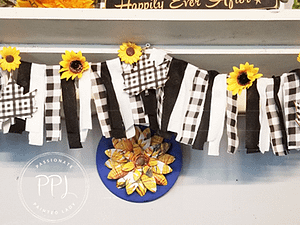 diy simple leaf banner using buffalo checks, wooden maple leaves, and sunflowers